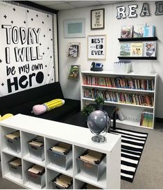 an office cubicle with bookshelves, shelves and pictures on the wall above it