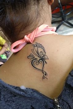 a woman with a tattoo on her back neck