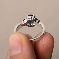 This is a gorgeous handmade creation. Its beauty is its simplicity & Elegance. The 6*8 mm oval shape faceted lab alexandrite is crafted in solid sterling silver and with rhodium plated. Main stone weight about 1.87 ct. Lab blue sapphire as accents. All item is sent in a beautiful gift box If you have any idea of design your ring,pls contact me directly. You can realize more lovely stuff clicking the link https://www.etsy.com/shop/knightjewelry?refshopsection_shophome_leftnav Please leave the Silver Oval Bezel Setting Wedding Rings, Tanzanite Oval Birthstone Promise Ring, Oval Tanzanite Birthstone Promise Ring, Elegant Oval Tanzanite Birthstone Ring, Oval Sapphire Ring For Promise, Oval Sterling Silver Wedding Ring With Accent Stones, Ethical Sapphire Oval Ring For Promise, Oval Ring With Center Stone Of Lab-created Sapphire, Oval Lab-created Sapphire Ring With Center Stone