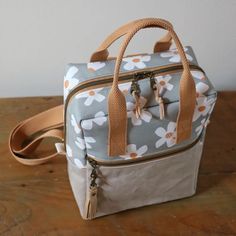 a flowered bag sitting on top of a wooden table