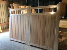 a wooden gate with lights on it in the middle of a room filled with furniture