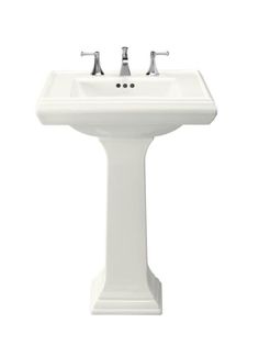 a white pedestal sink with two faucets