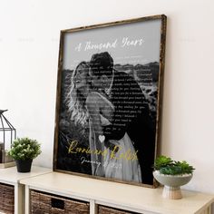 a wooden frame with a couple's poem on it next to some baskets and plants