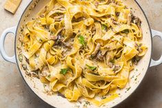 a pot filled with pasta and meat on top of a table