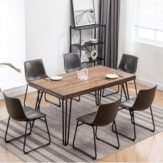 a dining room table with chairs and a rug