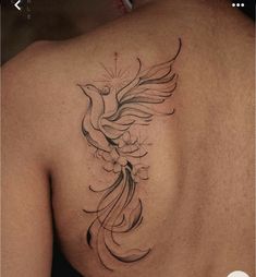 a bird tattoo on the back of a man