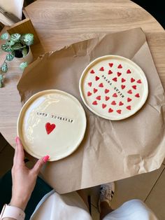 two plates with hearts on them sitting on top of a table