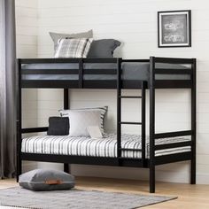 a black bunk bed sitting on top of a wooden floor