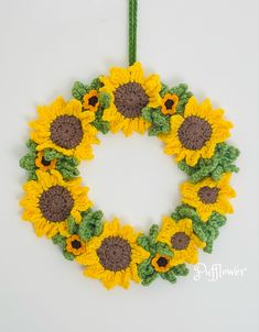 A stunningly beautiful handmade crochet sunflower wreath. It has five large sunflowers, two small sunflower and 5 small deeper yellow sunflowers. It has chunky green foliage around the sunflowers. Made in good quality chunky yarn, size is approximately fourteen inches wide.
Another beautiful design by Pufflower. Crochet Sunflower Wreath Free Pattern, Summer Crochet Wreath, Crochet Sunflower Wreath, Wreath Crochet, Crochet Wreaths, Crochet Flower Wreath, Crochet Wreath Pattern Free, Sunflower Crochet Pattern, Sunflower Wreath