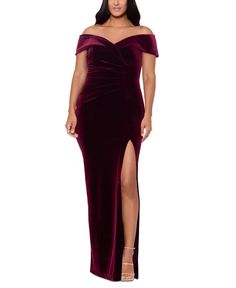 a woman wearing a long velvet dress with an off the shoulder slit