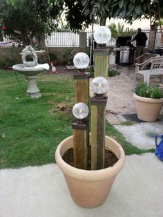 a potted planter filled with glass globes on top of it's sides