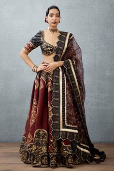 Burgundy bhagalpuri printed lehenga in heavy raw silk with side tassel tie-up. Paired with cutwork dupatta and printed blouse.
Components:3
Pattern:Printed
Type of Work:Hand Adda Work, Bhagalpuri Digital Print, Gota
Neckline:V Neck
Sleeve Type:Short Sleeves
Fabric:Lehenga and Choli: Heavy Raw Silk; Dupatta: Silk Organza
Color:Red,Black
Other Details:
Cutwork dupatta
Lace borders
Placement embroidery
Back cutout blouse
Occasion:Destination Wedding,Sangeet - Aza Fashions Red And Black Lehenga, Lehenga Designs Simple, Cutout Blouse, Work Lehenga, Lehenga Blouse Designs, Traditional Indian Dress, Indian Brides, Red Lehenga, Ghagra Choli