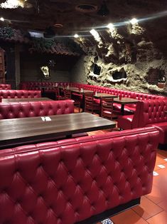 a restaurant with red leather booths and tables