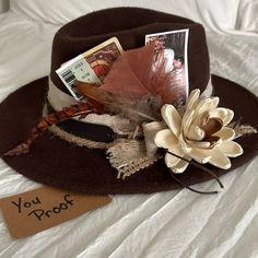 This One Of A Kind Fedora Is Hand Decorated Using New And Upcycled Materials. It Is Brown And Features Sola Wood Flower, Canvas Belt, Faux Leather Belt, Feathers And Morgan Wallen Ticket And Playing Card. Perfect For Festival, Night Out Or Concert. It Is 57cm But Has An Adjustable Ribbon To Tighten. Womens Straw Cowboy Hat, Felt Hats For Women, Womens Western Hats, Boho Hats, Hat Burning, Bohemian Hats, Hat Decor, Cowboy Decor, Women Fedora