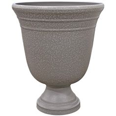 a large gray vase sitting on top of a white table