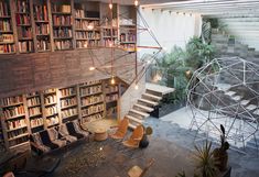 a room filled with lots of books and furniture