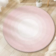 a pink and white circular rug on the floor