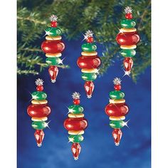 christmas ornaments hanging from a tree with blue sky in the backgroung background