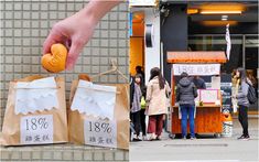 a person holding an orange in front of some bags