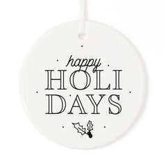 a white ornament with the words happy holi days on it and holly decorations