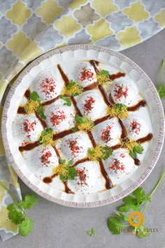 a white plate topped with lots of food on top of a table next to green leaves