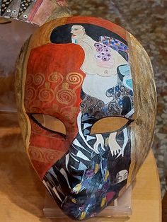 an artistic mask is displayed on a table