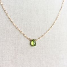 The gold peridot necklace is perfect for anyone with an August birthday. Fine Jewelry Lime Green Birthstone, Fine Jewelry Lime Green Gemstone, Elegant Peridot Birthstone Gemstones, Elegant Green Citrine Jewelry, Elegant Green Peridot Birthstone Necklace, Elegant Peridot Gemstone Gift, Elegant Peridot Gemstones As Gift, Elegant Peridot Gemstones For Gifts, Yellow Gold Peridot Gemstone Jewelry