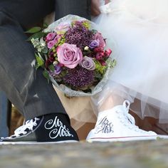 the bride and groom are holding bouquets in their hands as they sit next to each other