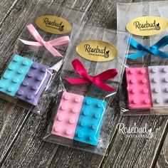 four packaged legos with bows on them