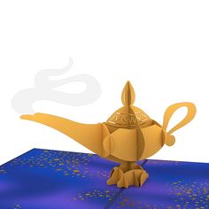 an origami bird sitting on top of a blue table with gold confetti