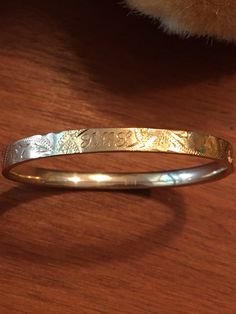 "This is a remarkable classic little girl baby bangle bracelet. Hand engraved, perfect clasp, excellent condition considering its age. One small \"love\" dent. Engraved initials LML which are very flowery and difficult to read. It measures approximately 3 1/16th\" wide , and oval is approximately 2\"x 1 3/4 \". Weighs approximately 4.6 gms. Marked 14kt in bracelet and clasp bar. Keepsake and an heirloom would make a delightful, unique baby gift or a gift to a little girl to keep forever! Inside Hallmarked 14k Gold Bracelet, 14k Gold Round Chain Bracelet, Classic Etched Gold Bracelet For Formal Occasions, Classic Etched Gold Bracelet, Heirloom Gold Bracelet For Ceremonial Occasions, Etched Yellow Gold Bracelet For Anniversary, Antique Yellow Gold Hallmarked Bangle, Antique Engraved Yellow Gold Bracelet, Antique Hallmarked Yellow Gold Bangle