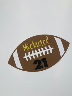 a football shaped magnet with the number 21 on it's side is shown in front of a white background