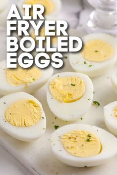 boiled eggs on a cutting board with the words air fryer boiled eggs over them