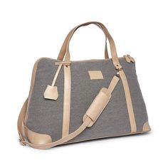 The perfect tote bag for any adventure. Large enough to fit several outfits and small enough to throw in your passenger seat, this light grey canvas bag features a long adjustable and removable shoulder strap, vegan leather accents, and satin interior lining. (#2727) •Dimensions: 26.50"L x 9.75"W x 13.75"H Grey Tote Bags, Grey Tote, Passenger Seat, Leather Duffle, Perfect Tote Bag, Monogrammed Items, Strap Tops, Duffel Bag, Weekender Bag