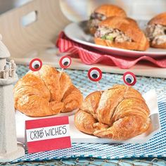 some croissants with googly eyes are on a table