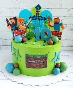 a green cake decorated with minecraft characters and numbers on it's top tier