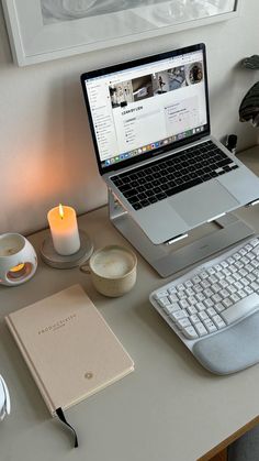 an open laptop computer sitting on top of a desk next to a keyboard and mouse