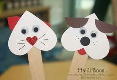 two paper cat and dog puppets on wooden sticks