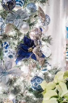 a christmas tree decorated with blue and silver ornaments