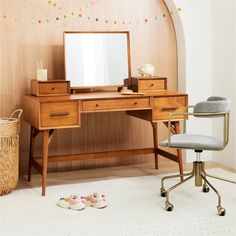 a desk with a mirror, chair and shoes on the floor