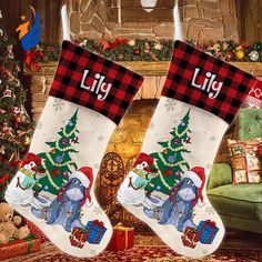 two christmas stockings with elephants on them in front of a fire place and presents under the tree