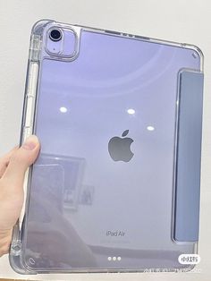 someone holding an ipad in their hand with the case on it's back side