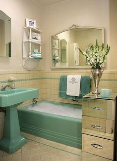 a bathroom with a tub, sink and mirror