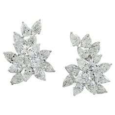 If you are getting ready for gala season, which in New York City, runs from Fall through Spring, you might be searching for a quintessentially elegant pair of diamond earrings to frame your face in radiance. This stunning pair of Spectra Fine Jewelry Diamond Cluster Button Earrings, made in the 21st century are perfect for your big night out. The sparkling mirror-image pair is crafted in platinum and features 30 pear-shape diamonds with an estimated weight of 29.25 carats total. Nine of the thirty diamonds which weigh around one carat apiece are certified by the Gemological Institute of America (GIA), stating that some are of D-E-F color, some G-H with a clarity range that includes VS2 and SI1- SI2. Individual reports will be provided to interested buyers. The three-dimensional jewels capt Real Diamond Earrings, Diamond Cluster Earrings, Radiant Diamond, Antique Earrings, Pear Shaped Diamond, Cluster Earrings, Diamond Bracelets, Diamond Cluster, Real Diamonds