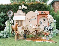 an outdoor party with fake animals and decorations