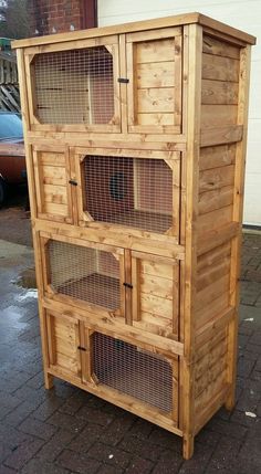 a wooden cabinet sitting on top of a brick sidewalk