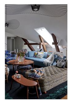 a living room filled with lots of furniture and decor on top of a blue rug