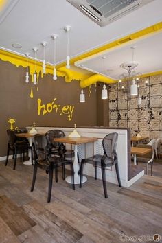 an empty restaurant with honey painted on the wall