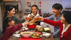 a group of people sitting around a table with food and drinks