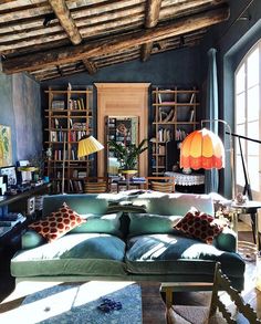 a living room filled with furniture and bookshelves